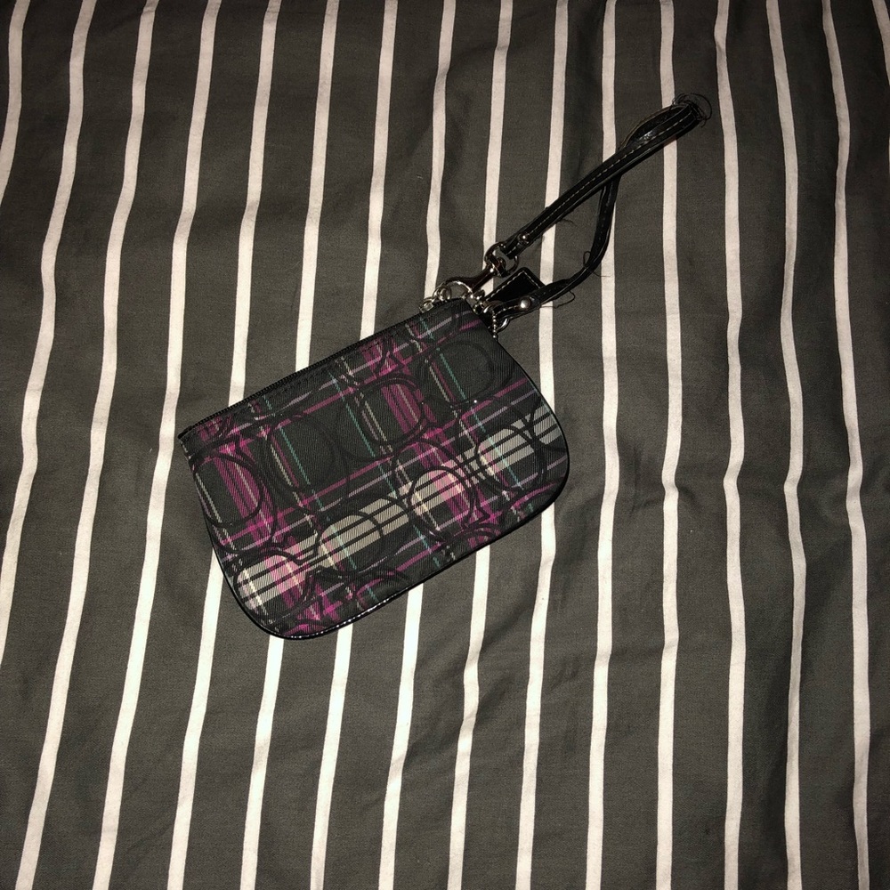 Multicolored coach wrist wallet.